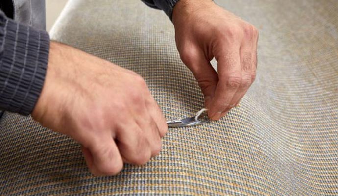 Worker repairing carpet