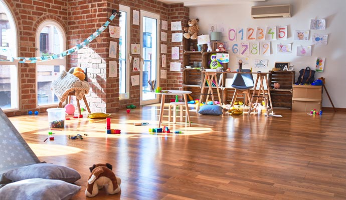 day care playroom with colorful furniture and toys empty room cleaning