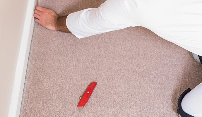 https://www.kleandry.com/images/handyman-laying-down-carpet-tack-strip-replacement-and-repair.jpg