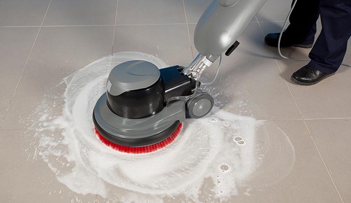 Man cleaning tile and grout professionally