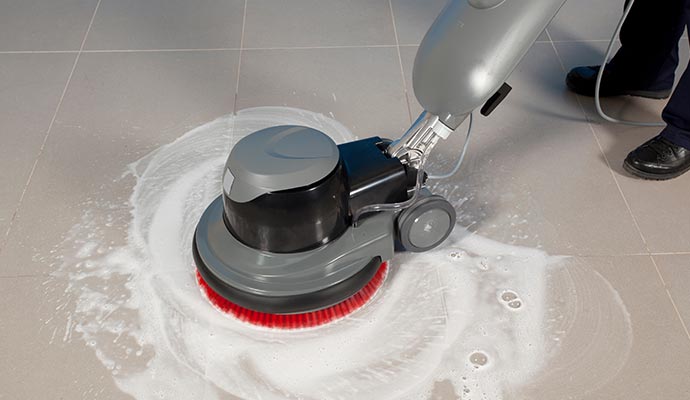 man tile and grout cleaning with machine